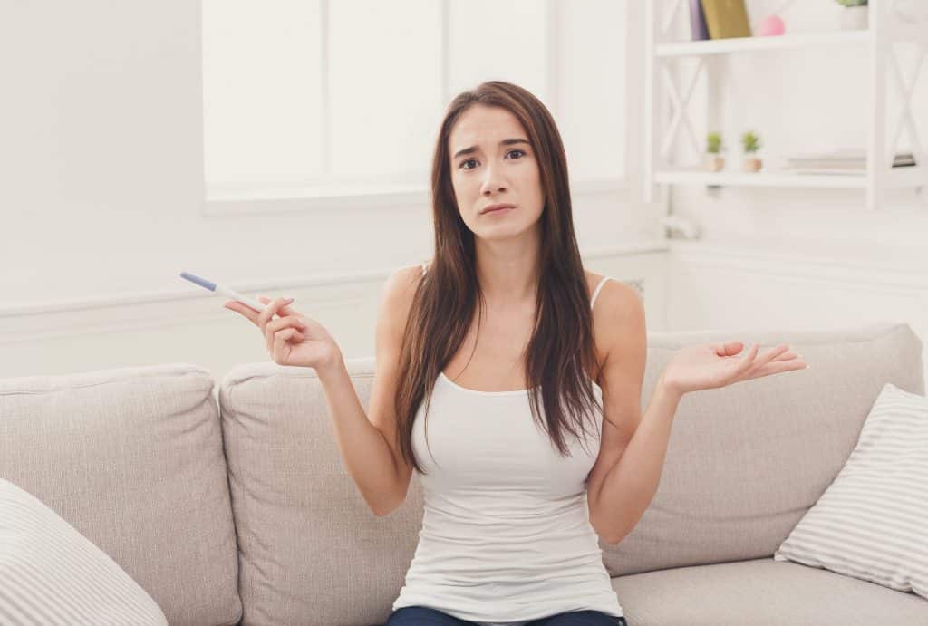 Worried girl with negative pregnancy test
